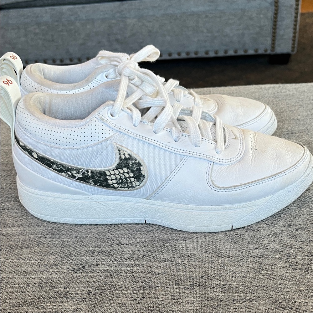 Nike White Low-Top Sneakers with Black Snakeskin Swoosh Accent